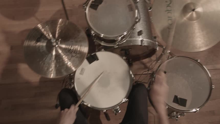 A first person perspective shows a man skillfully plays a set of drums