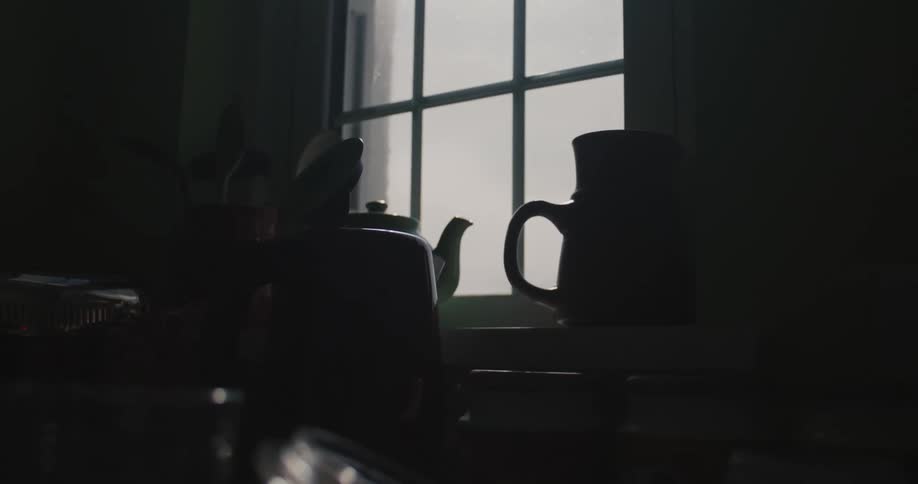 Closeup of a sink with bags next to a window
