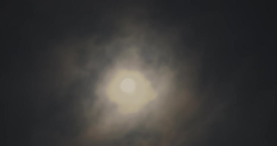 The sun shines through an overcast sky