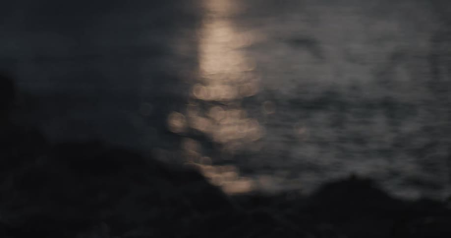 A view of the sea coast with reflection of sunlight and everything is blurred