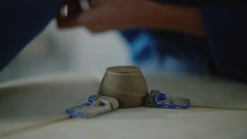 A clip of a person producing a cup