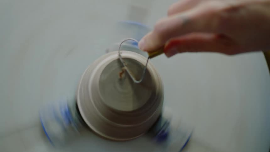 Womans hands modeling a small porcelain vase