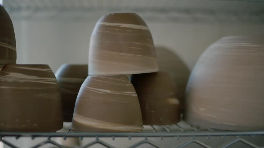 Clay pots on a metal shelf