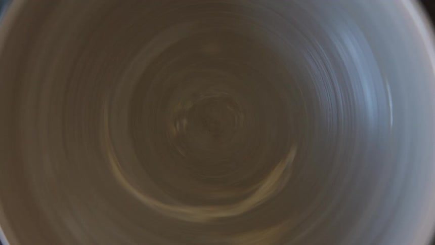 A clay bowl rotating on a rotating base