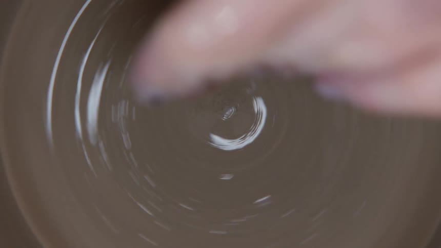 Closeup on a swirling liquid clay