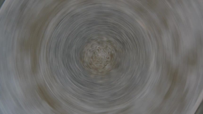 Close up of dull surface with a series of concentric circles at the center