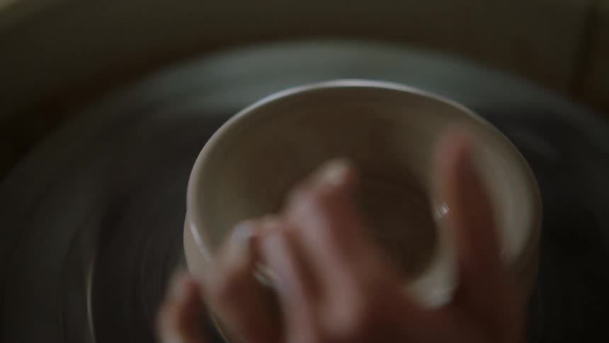 A person is sculpting clay