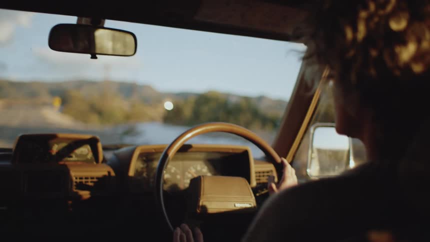 Woman driving a vehicle on a dirt road