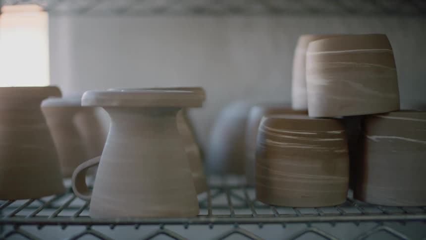 Various pieces of pottery sitting on a shelf