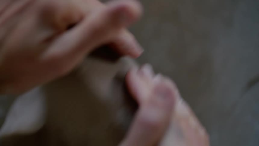 A clip of a person molding a clay