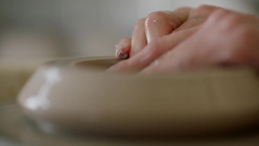 A person is using clay to sculpt