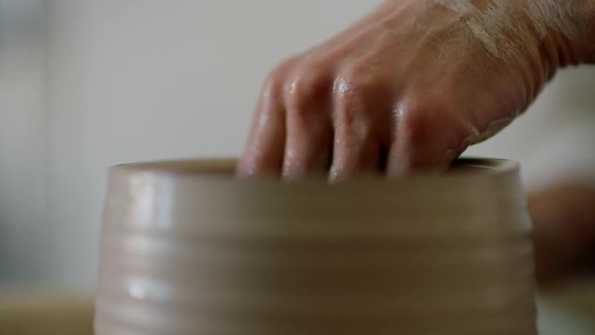 A person is sculpting clay
