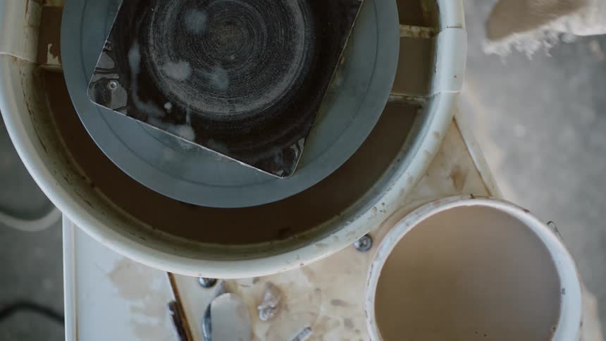 Person passing water through a machine and then using a cloth to dry