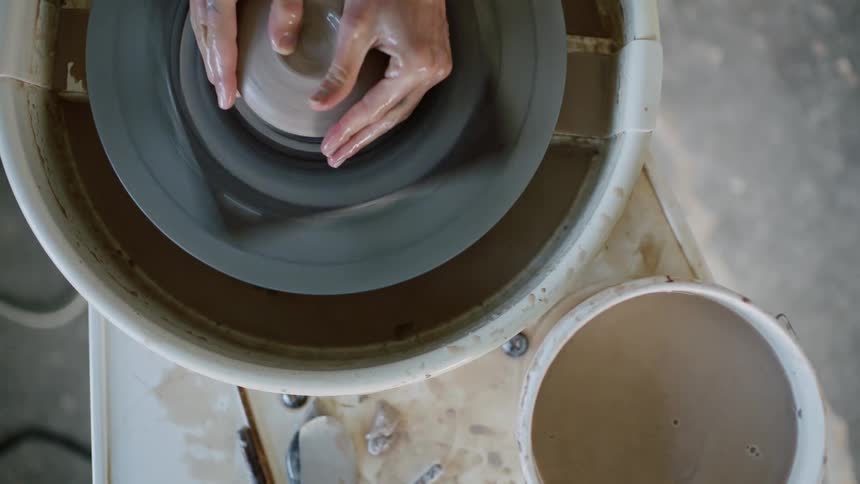 A person creating a clay sculpture