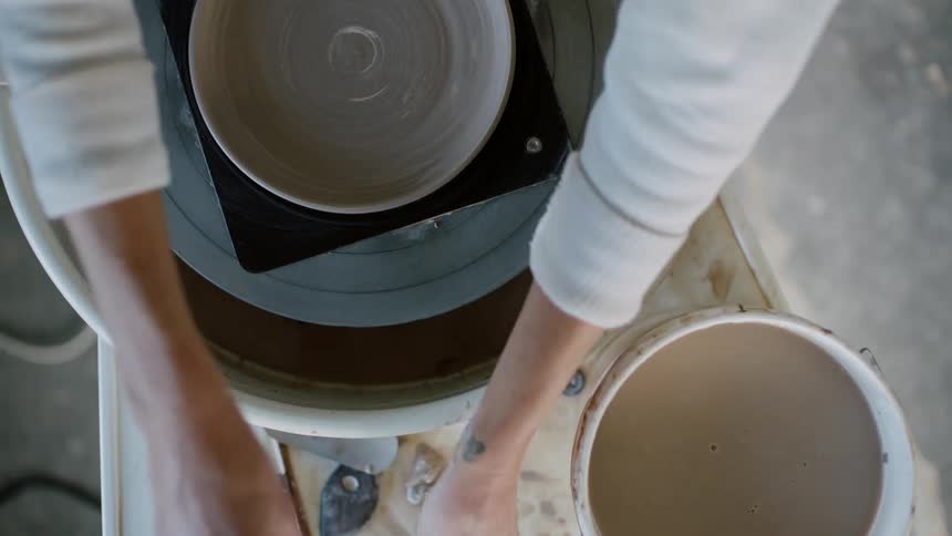 Female sculptor making a bowl on the sculpting wheel