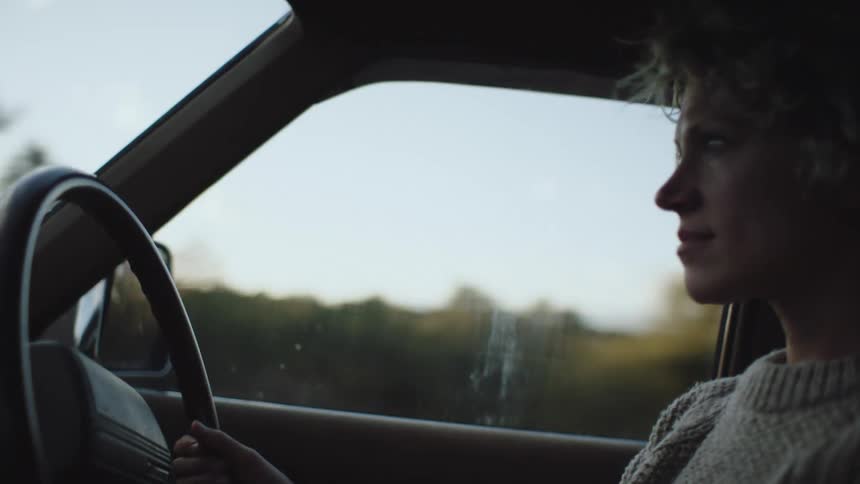 Lady driving a car during the day
