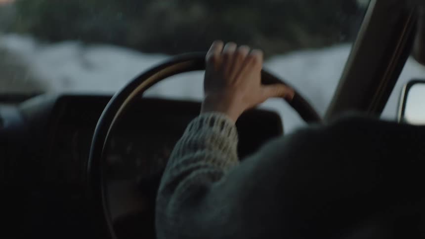 A person driving a vehicle during sunset