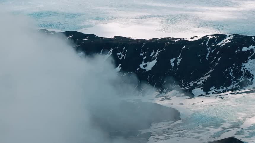 Aerial of mountains covered in ice and snow during winter