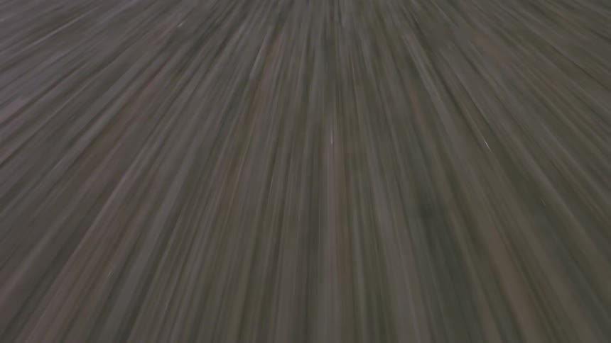 Intermittent yellow line contrasts with road surface during trip