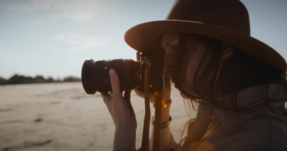 Closeup of a womans face photographing the natural landscape during the day