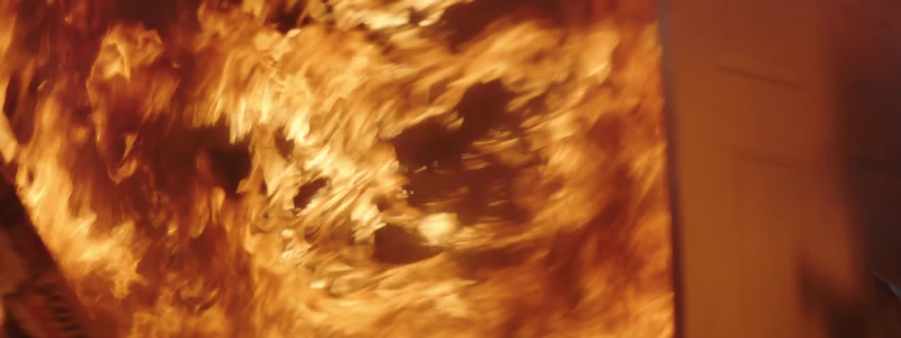 Two firefighters break into a house on engulfed in flames