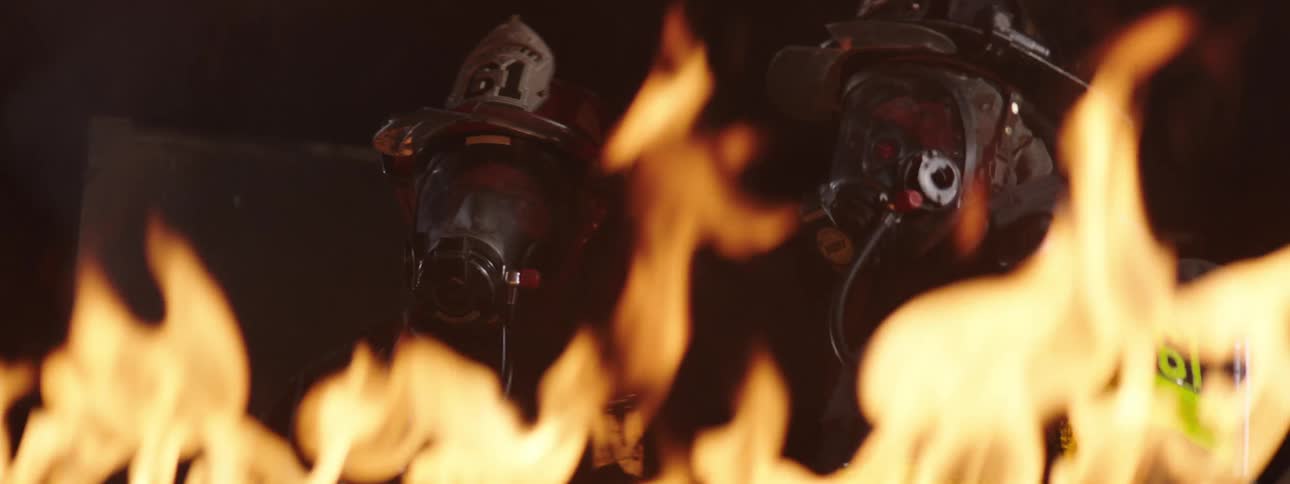 Firefighters fighting the flames of a fire