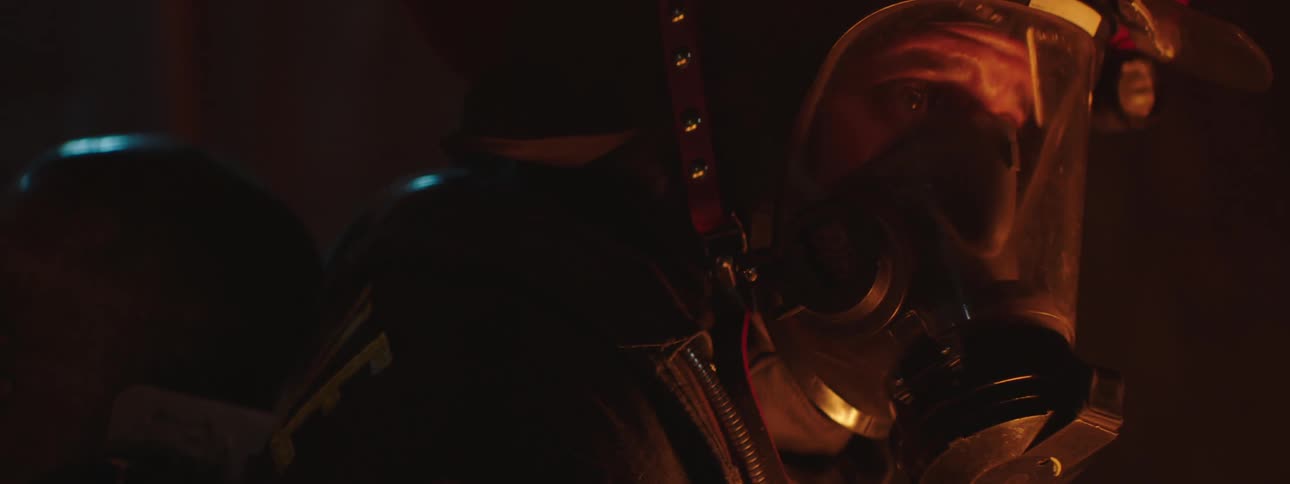 Man inside a special suit with protective mask inside a good dark environment at night