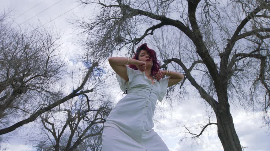 A woman dancing outdoors on a winter day