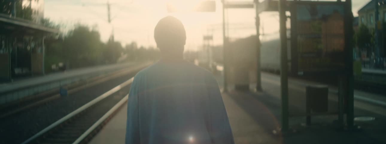 Man walking in an openair train station