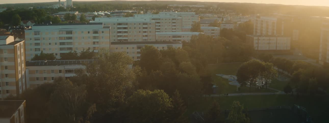 A view of some buildings in a city on a summer day