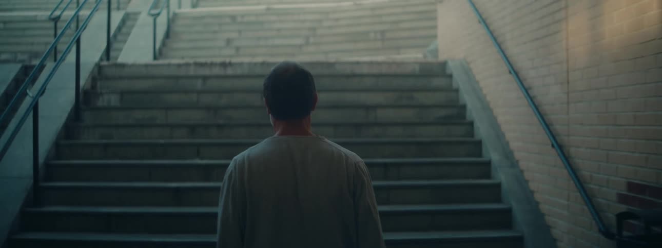 A person climbs a staircase in the city during the day
