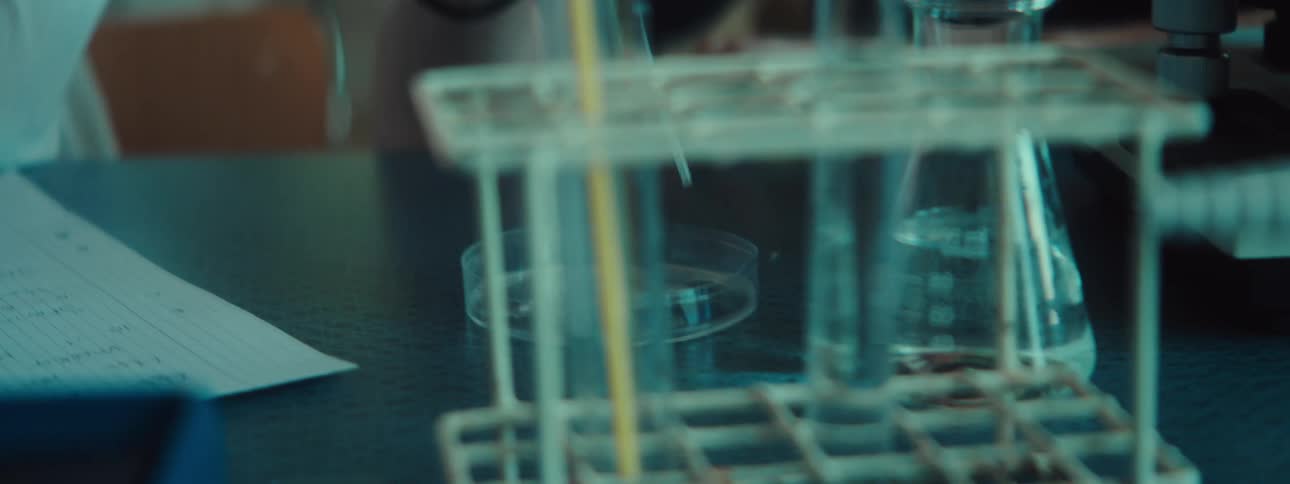 A person uses a microscope in a lab