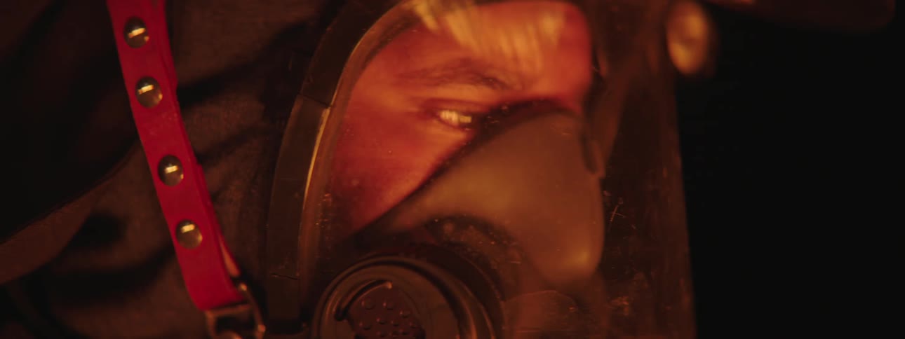A face of a person who is looking at a glowing object and she is wearing a mask