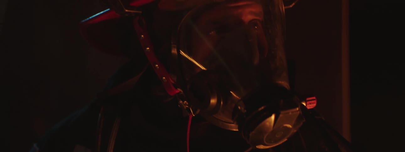 A firefighter in full gear looks fearful