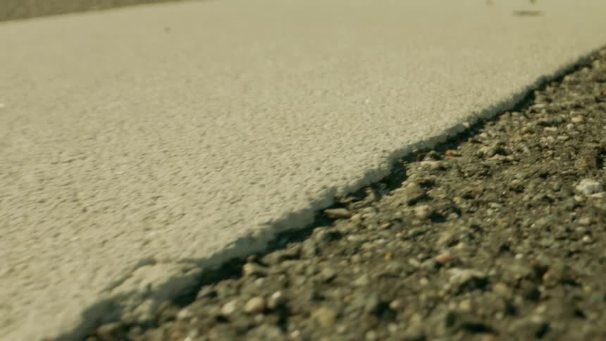 Closeup on a concreted ground and boulders next to it