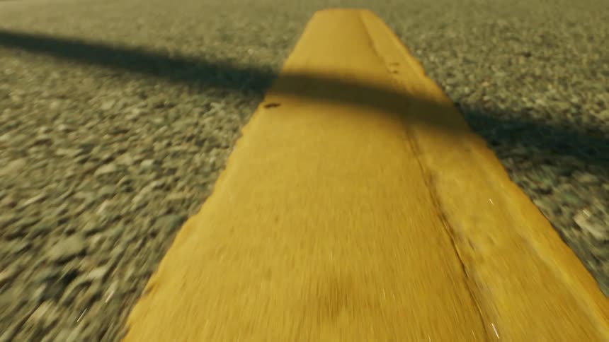 A yellow line is painted on the road
