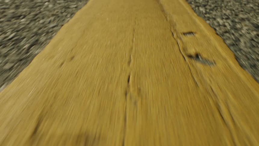 Gravel with a brown substance overlaying it