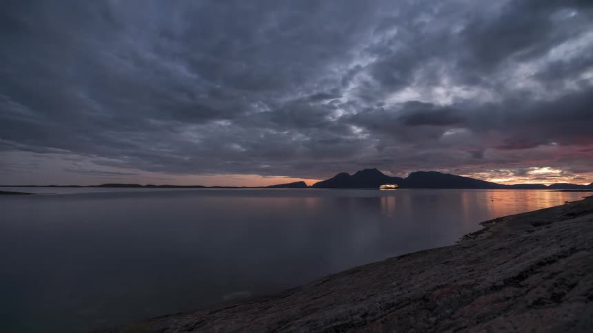 A time laps of a coastal area captures the transition from night to daytime