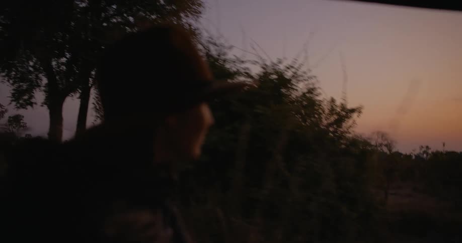 Portrait of a young woman moving through a savannah on a morning