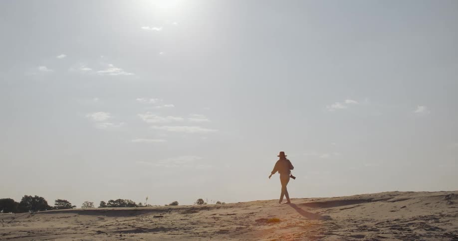 A woman is walking on the beach