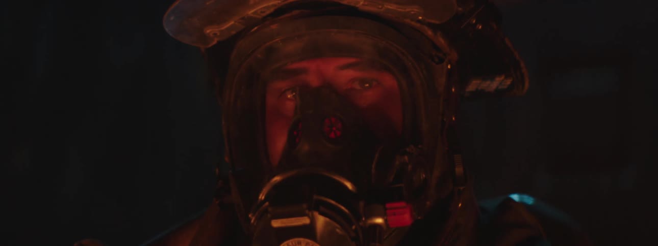 Portrait of a firefighter with oxygen protection mask inside an indoor environment with ceiling