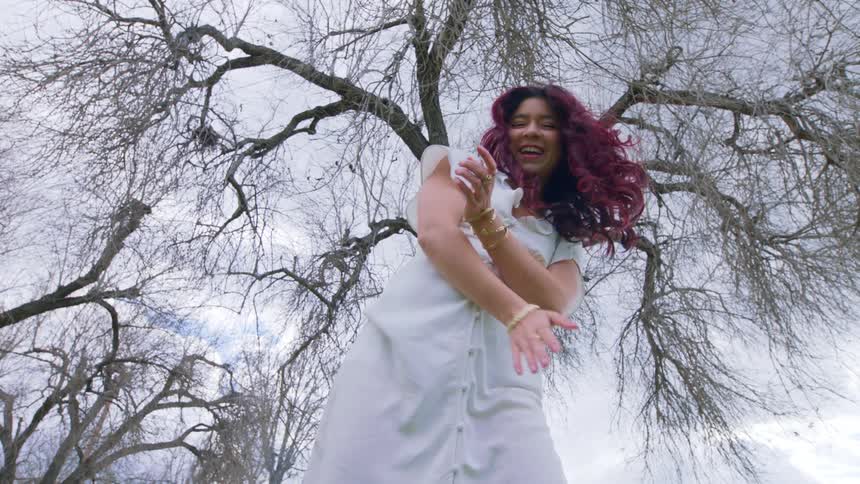 A woman smiles as she dances