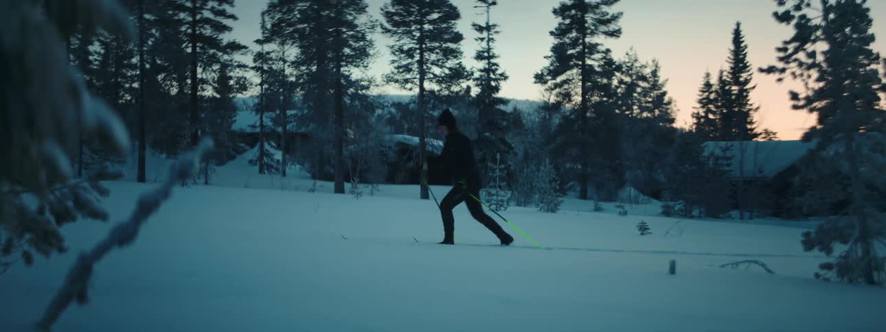 A person with skis on moves across snow
