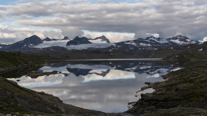 A lake sitting near mountains