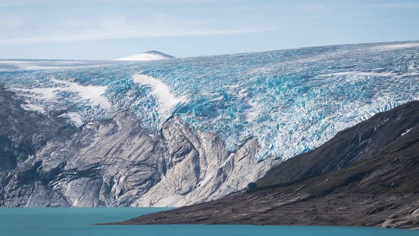 Time lapse of clouds and shadows moving over a glacier in the daytime
