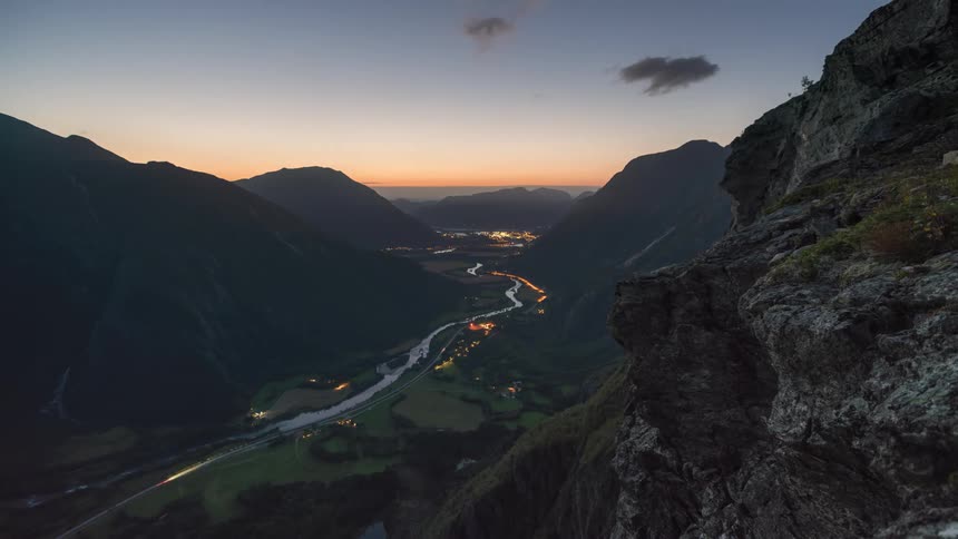 A time lapse of a road crossing a valley
