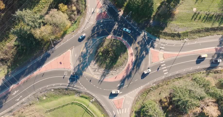 Birds eye view over cars crossing a roundabout