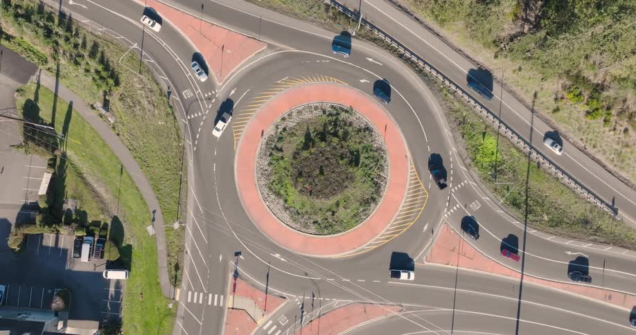 Top down view of traffic flowing through a large roundabout