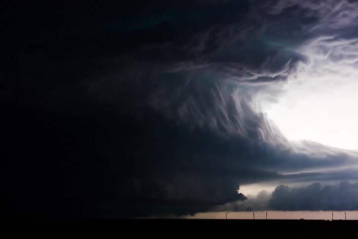 As storm clouds gather ominously overhead lightning streaks across the darkened sky heralding the imminent arrival of a powerful hurricane