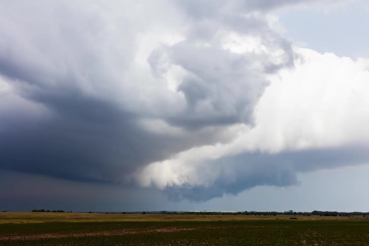 Time lapse of clouds rolling over a grass field